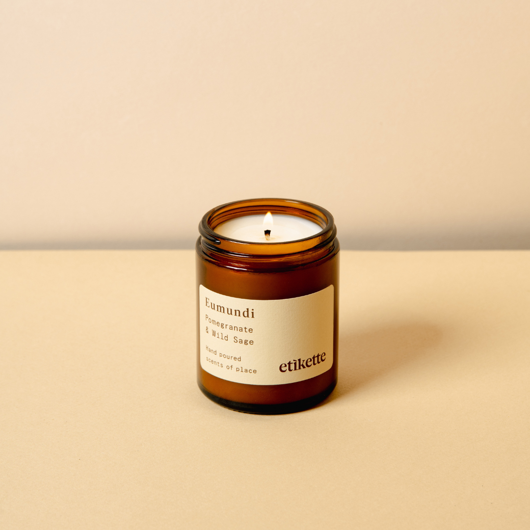 Eumundi in Pomegranate & Wild Sage candle, lit