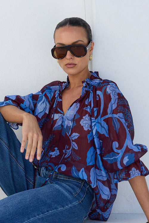 Expedition Burgundy Blue Floral Shirred Neck Top - seated, styled with denim
