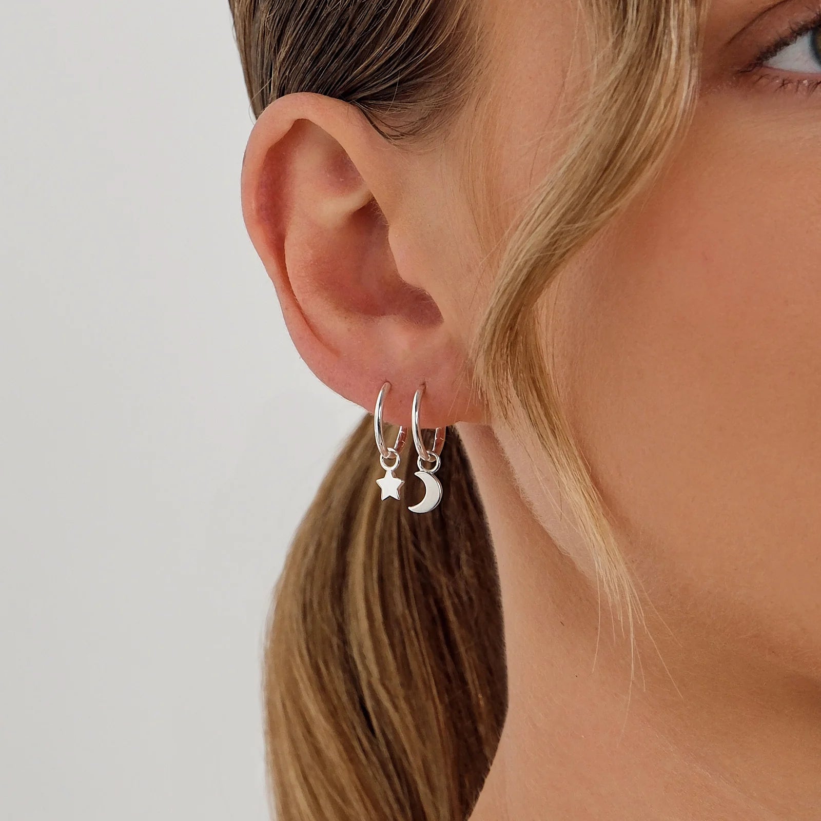 star-moon-charm-huggie-hoop-earrings-silver.webp