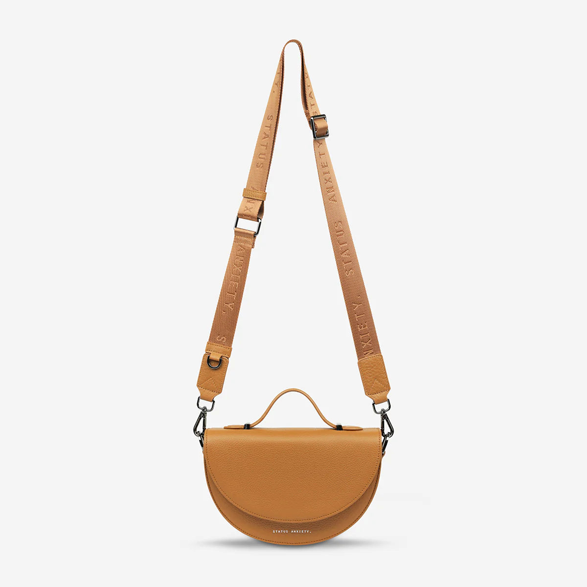status-anxiety-bag-all-nighter-thin-webbed-strap-tan-front-hanging.webp