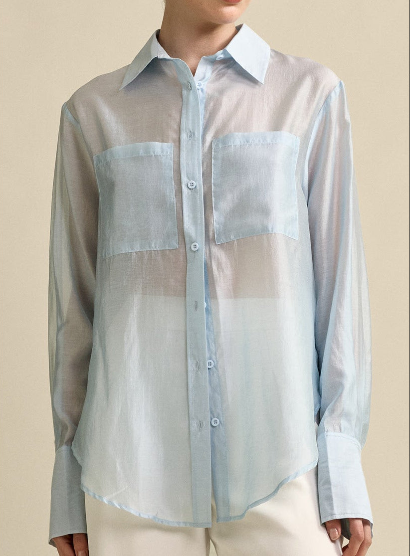 MVN Sheer Pocket Shirt in blue, worn with white wide-leg pants